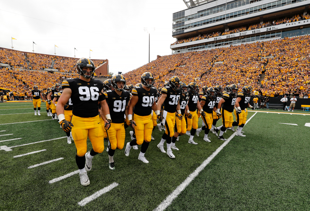 The Iowa Hawkeyes swarm onto the field against the Northern Illinois Huskies Saturday, September 1, 2018 at Kinnick Stadium. (Brian Ray/hawkeyesports.com)