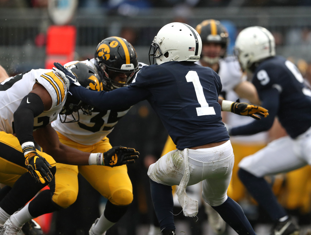Iowa Hawkeyes wide receiver Dominique Dafney (23) hits Penn State Nittany Lions wide receiver KJ Hamler (1) on a kick off Saturday, October 27, 2018 at Beaver Stadium in University Park, Pa. (Brian Ray/hawkeyesports.com)