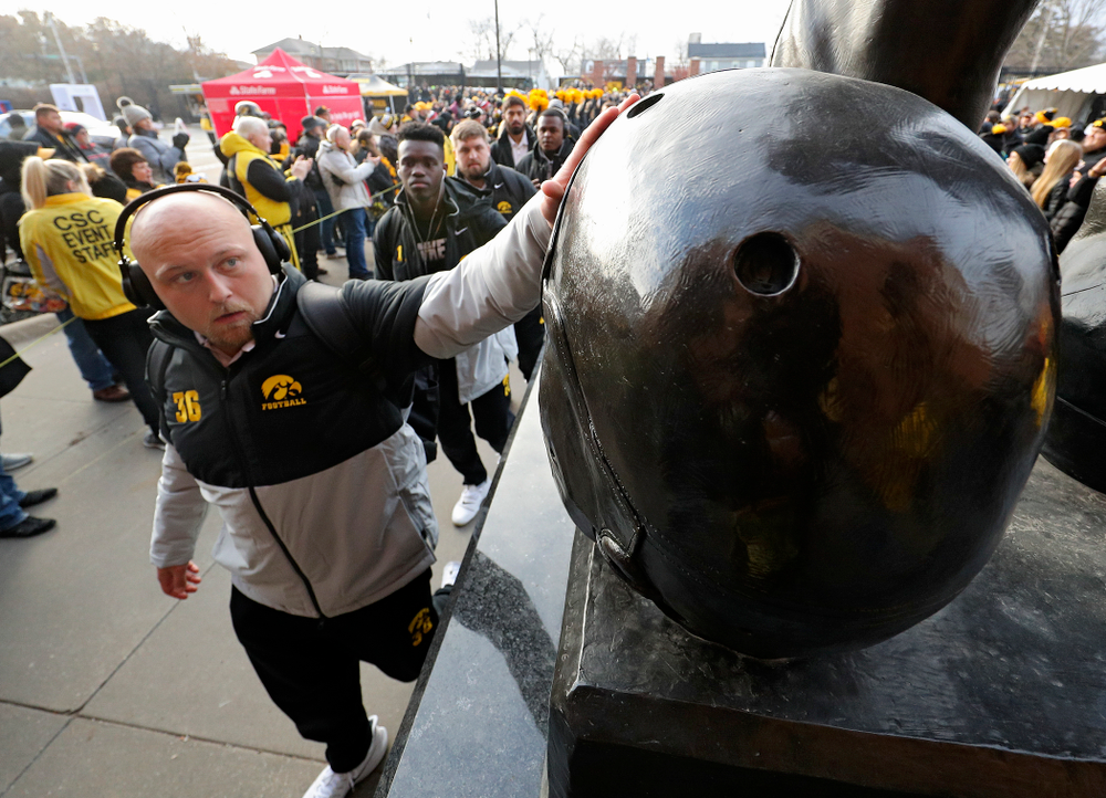 Iowa Hawkeyes fullback Brady Ross (36) touches the helmet on the Nile Kinnick statue before their game at Kinnick Stadium in Iowa City on Saturday, Nov 23, 2019. (Stephen Mally/hawkeyesports.com)