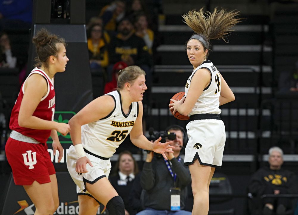 Iowa Hawkeyes guard Mckenna Warnock (14) pulls down a rebound during the second quarter of their game at Carver-Hawkeye Arena in Iowa City on Sunday, January 12, 2020. (Stephen Mally/hawkeyesports.com)