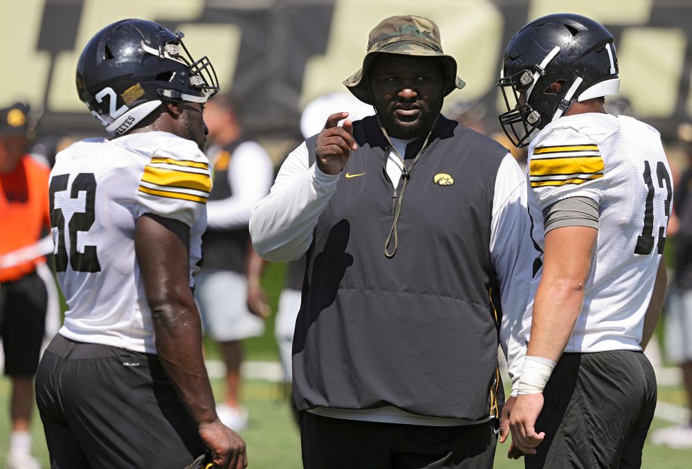 Iowa Hawkeyes defensive line coach Kelvin Bell talks with linebacker Amani Jones (52) and linebacker Joe Evans (13) during Fall Camp Practice No. 7 at the Hansen Football Performance Center in Iowa City on Friday, Aug 9, 2019. (Stephen Mally/hawkeyesports.com)