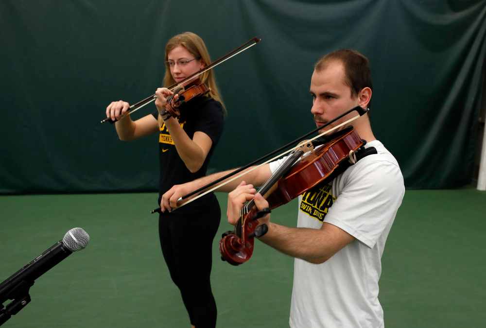 Iowa Diver Anton Hoherz and Women's Tennis Player Montana Crawford play the National Anthem before the Iowa Hawkeyes game against Purdue Sunday, April 15, 2018 at the Hawkeye Tennis and Recreation Center. (Brian Ray/hawkeyesports.com)