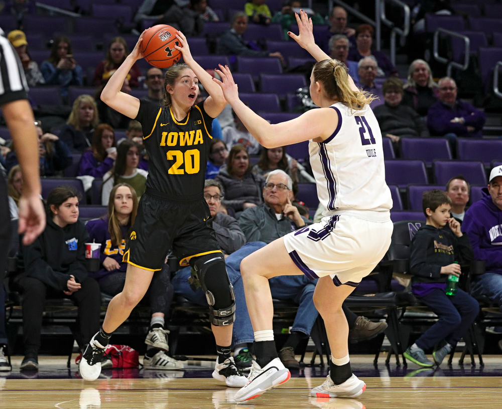 Iowa Hawkeyes guard Kate Martin (20) looks to pass during the fourth quarter of their game at Welsh-Ryan Arena in Evanston, Ill. on Sunday, January 5, 2020. (Stephen Mally/hawkeyesports.com)