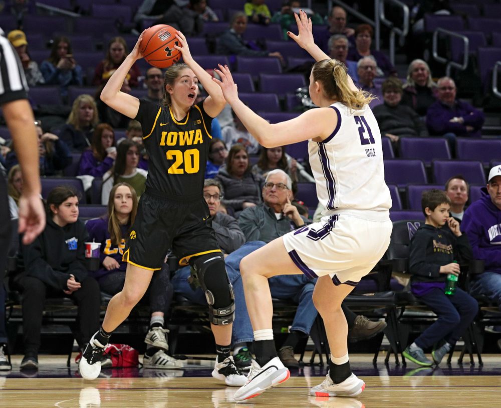 Iowa Hawkeyes guard Kate Martin (20) looks to pass during the fourth quarter of their game at Welsh-Ryan Arena in Evanston, Ill. on Sunday, January 5, 2020. (Stephen Mally/hawkeyesports.com)