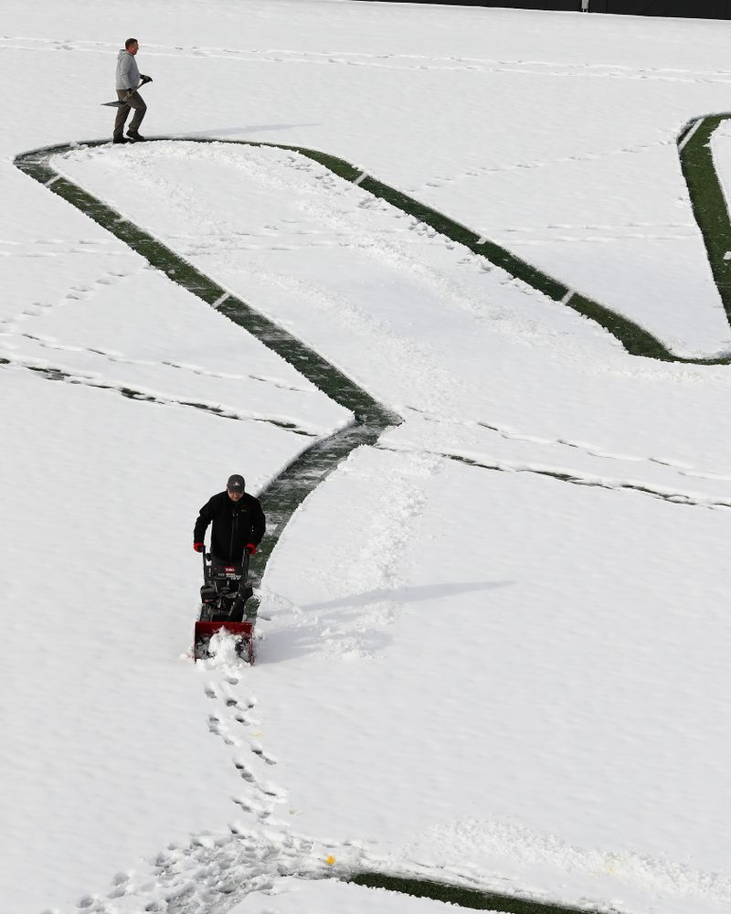 Members of the Iowa Athletics Turf Management staff create the #SnowWave for kids in the Stead Family Children's Hospital Thursday, February