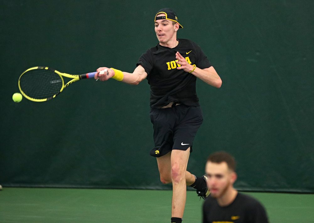 Iowa’s Nikita Snezhko (top) returns a shot as Kareem Allaf looks on during their doubles match at the Hawkeye Tennis and Recreation Complex in Iowa City on Friday, March 6, 2020. (Stephen Mally/hawkeyesports.com)