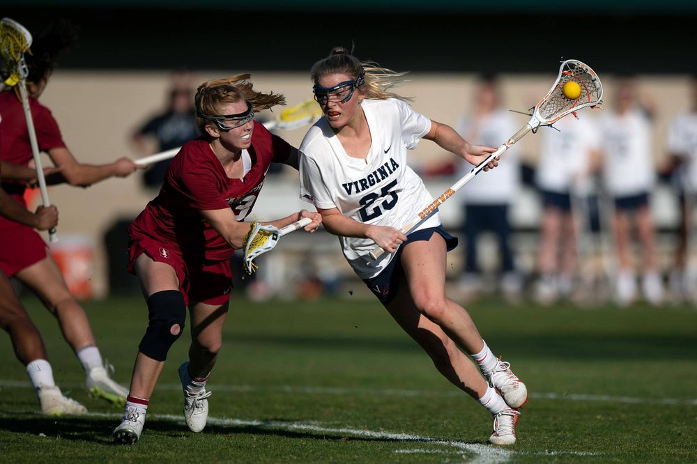 STANFORD, California - FEBRUARY 14: Virginia Cavaliers midfield Courtlynne Caskin (25) is defended by Stanford Cardinal attack Kelleigh Keating (23) during the first half at Cagan Stadium on February 14, 2020 in Stanford, California. The Virginia Cavaliers defeated the Stanford Cardinal 12-11. (Photo by Jason O. Watson)