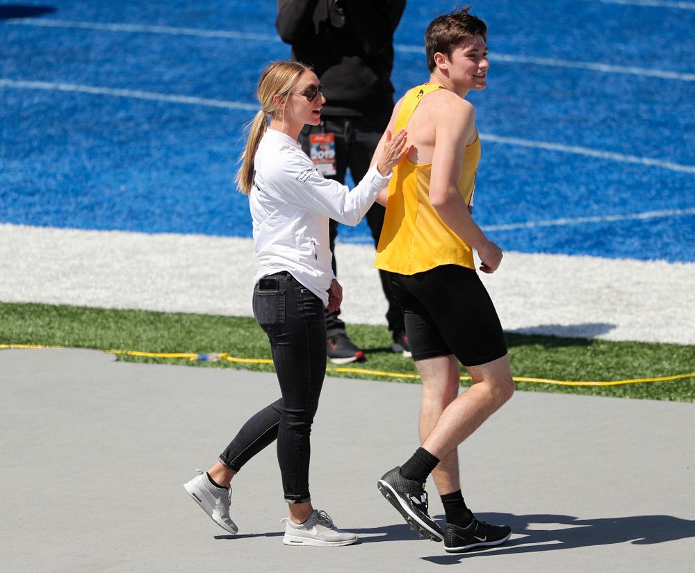 Iowa assistant coach Paige Knodle (from left) talks with Jay Hunt during the men's high jump event during the second day of the Drake Relays at Drake Stadium in Des Moines on Friday, Apr. 26, 2019. (Stephen Mally/hawkeyesports.com)