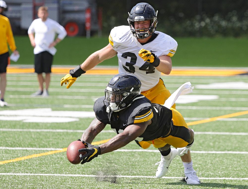 Iowa Hawkeyes running back Mekhi Sargent (10) dives for a pass as linebacker Kristian Welch (34) looks on during Fall Camp Practice #5 at the Hansen Football Performance Center in Iowa City on Tuesday, Aug 6, 2019. (Stephen Mally/hawkeyesports.com)
