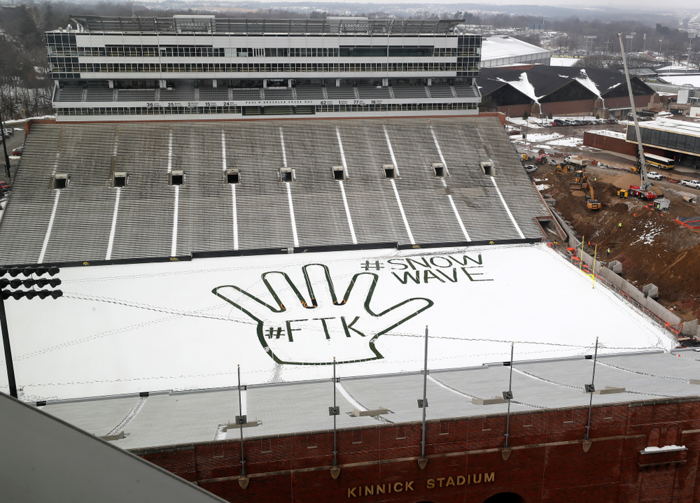 Members of the Iowa Athletics Turf Management staff create the #SnowWave for kids in the Stead Family Children's Hospital Thursday, February