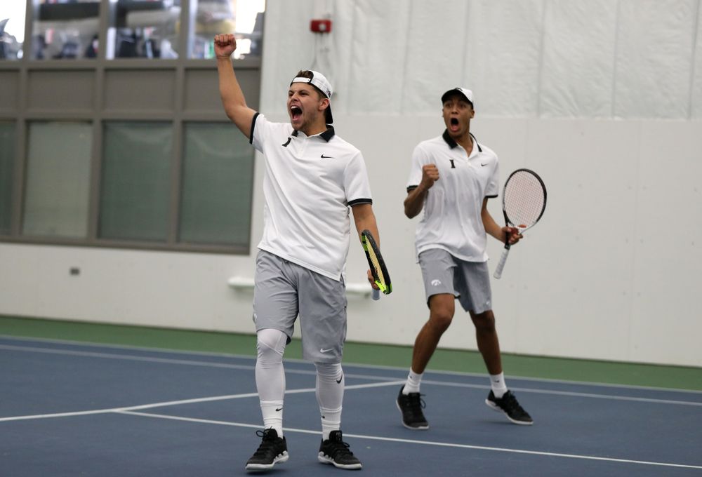 Iowa's Will Davies and Oliver Okonkwo celebrate after winning a doubles match against Western Michigan Saturday, January 19, 2019 at the Hawkeye Tennis and Recreation Complex. (Brian Ray/hawkeyesports.com)