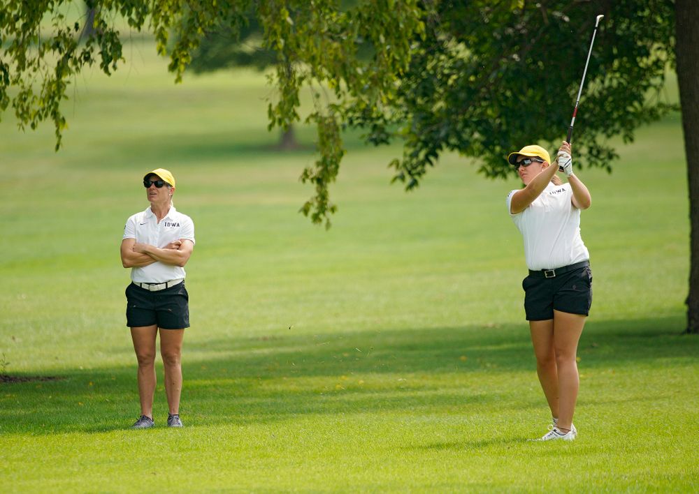 Iowa’s Sarah Overton (right) watches her shot as head coach Megan Menzel looks on during their dual against Northern Iowa at Pheasant Ridge Golf Course in Cedar Falls on Monday, Sep 2, 2019. (Stephen Mally/hawkeyesports.com)