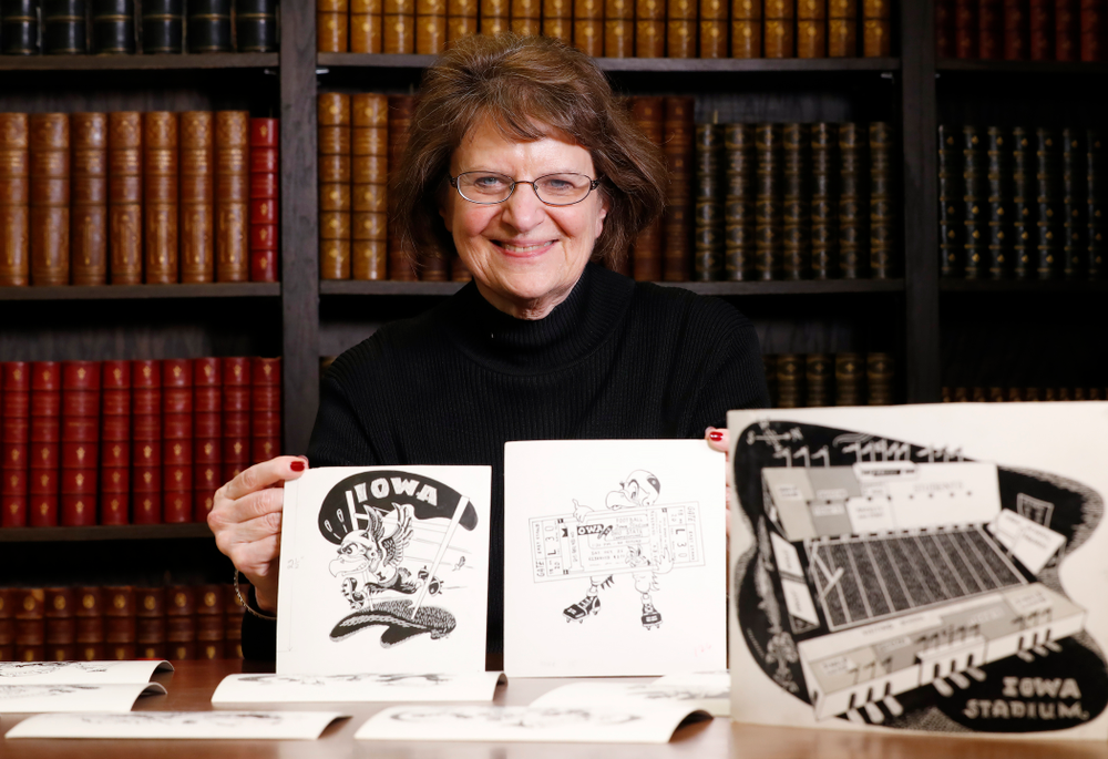 Jane Roth sits with some of the original drawings of Herky the Hawk Friday, April 20, 2018 at the University of Iowa Library. Roth has donated the drawings, which were created by artist Dick Spencer, to the library's special collection. (Brian Ray/hawkeyesports.com)