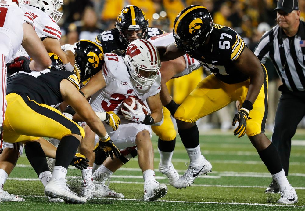 The Iowa Hawkeyes defense swarms Wisconsin Badgers running back Garrett Groshek (37) during a game against Wisconsin at Kinnick Stadium on September 22, 2018. (Tork Mason/hawkeyesports.com)