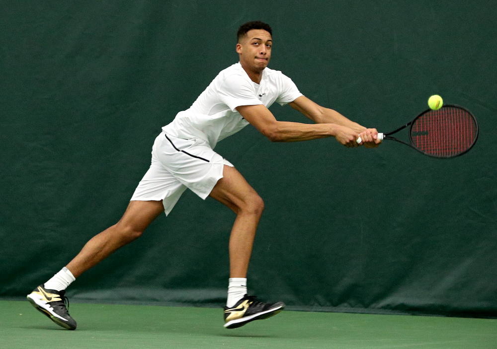 Iowa’s Oliver Okonkwo returns a shot during his singles match at the Hawkeye Tennis and Recreation Complex in Iowa City on Sunday, February 16, 2020. (Stephen Mally/hawkeyesports.com)