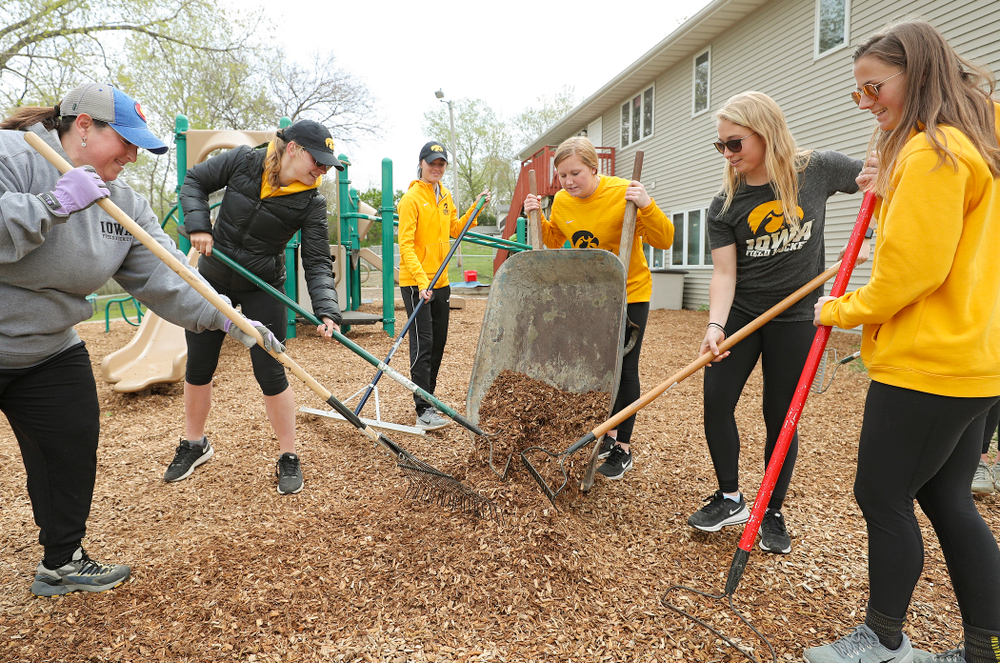 Iowa field hockey players re-mulch the playground at the HACAP Coral Ridge Head Start Center during the 21st annual ISAAC Hawkeye Day of Caring in Coralville on Sunday, Apr. 28, 2019. (Stephen Mally/hawkeyesports.com)