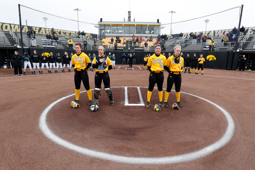 Iowa Hawkeyes starting pitcher/relief pitcher Mallory Kilian (11), catcher Angela Schmiederer (12), starting pitcher/relief pitcher Kenzie Ihle (22), and infielder Sarah Kurtz (9) against UW Green Bay Tuesday, March 27, 2018 at Bob Pearl Field. (Brian Ray/hawkeyesports.com)