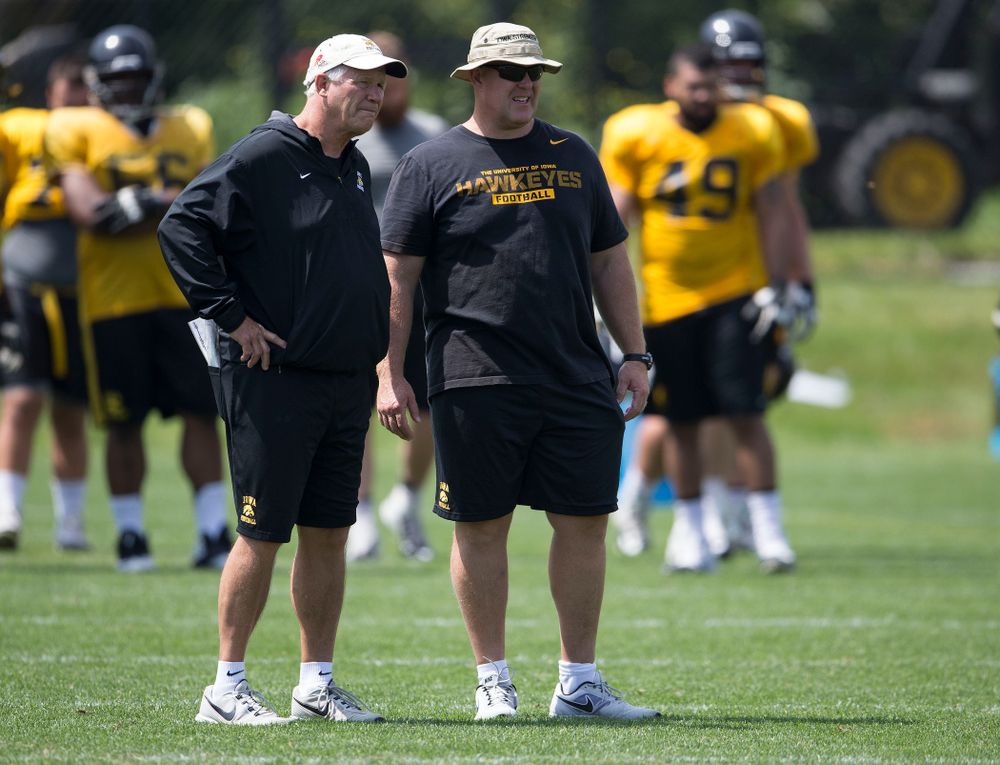 Iowa Hawkeyes Defensive Line coach Reese Morgan and Strength and Conditioning coach Chris Doyle talk during the team's sixth practice of camp Saturday, Aug. 9, 2014 at the Hayden Fry Football Complex in Iowa City. (Brian Ray/hawkeyesports.com)