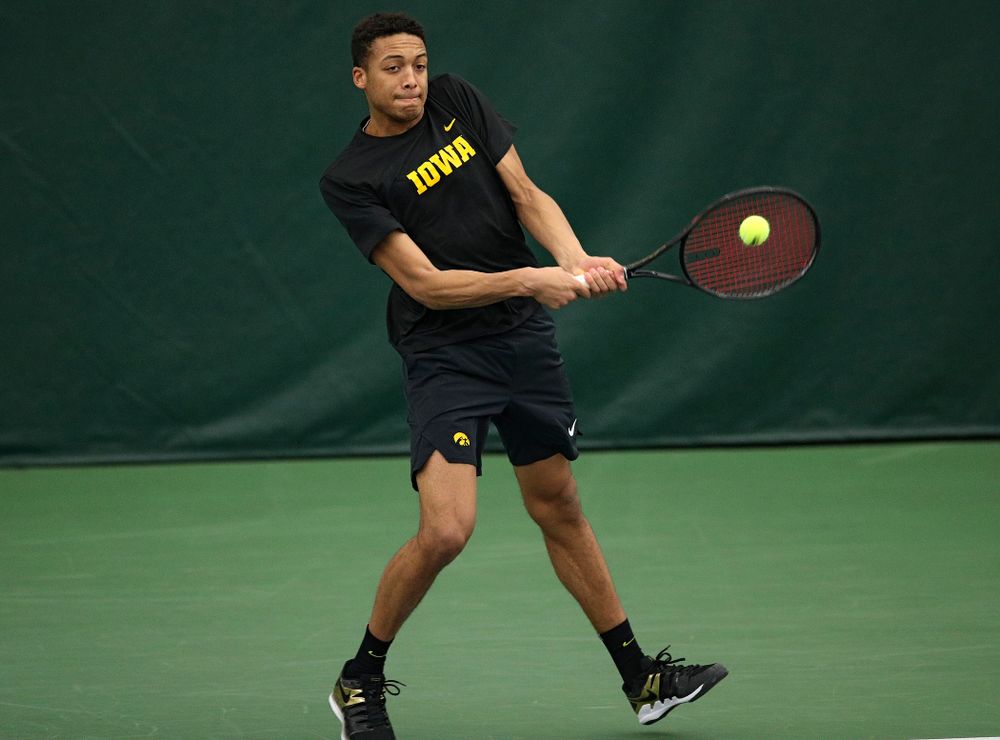 Iowa’s Oliver Okonkwo returns a shot during his doubles match at the Hawkeye Tennis and Recreation Complex in Iowa City on Friday, March 6, 2020. (Stephen Mally/hawkeyesports.com)