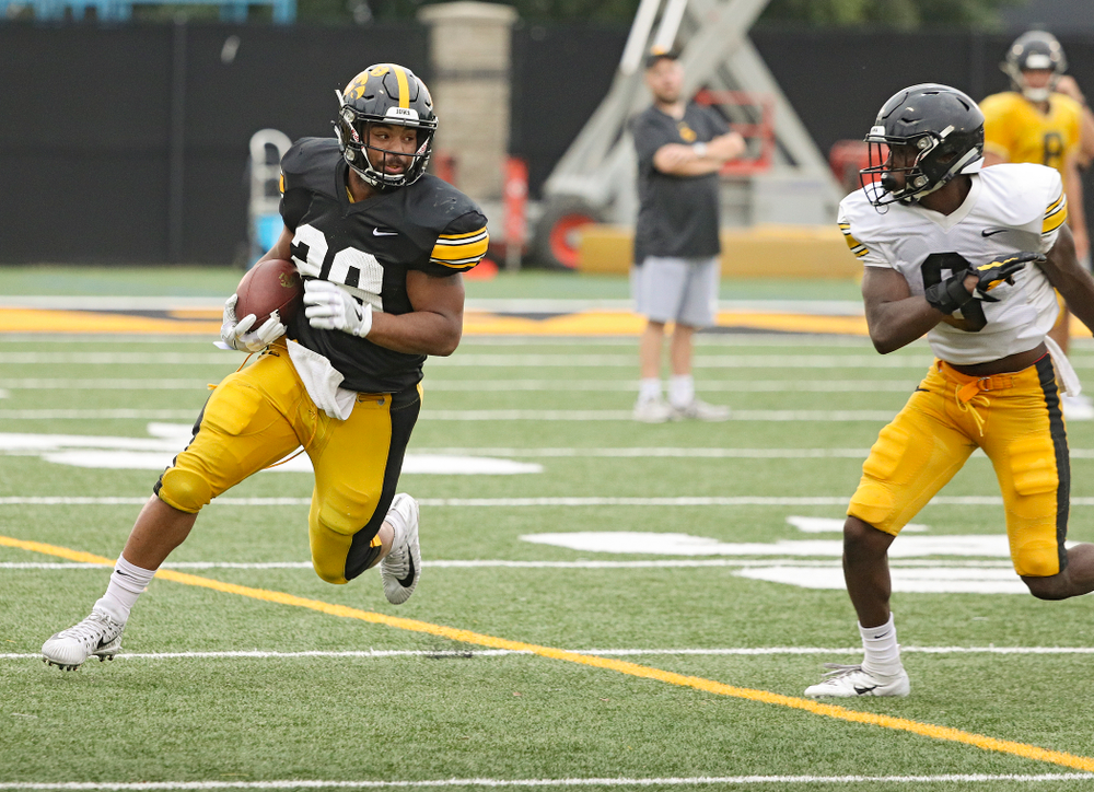 Iowa Hawkeyes running back Toren Young (28) eyes defensive back Matt Hankins (8) on a run durning Fall Camp Practice No. 17 at the Hansen Football Performance Center in Iowa City on Wednesday, Aug 21, 2019. (Stephen Mally/hawkeyesports.com)