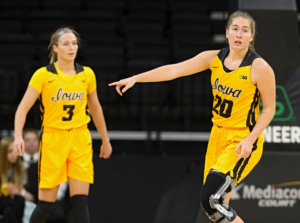Iowa guard Kate Martin (20) points as she runs back on defense during the first quarter of their game against Winona State at Carver-Hawkeye Arena in Iowa City on Sunday, Nov 3, 2019. (Stephen Mally/hawkeyesports.com)