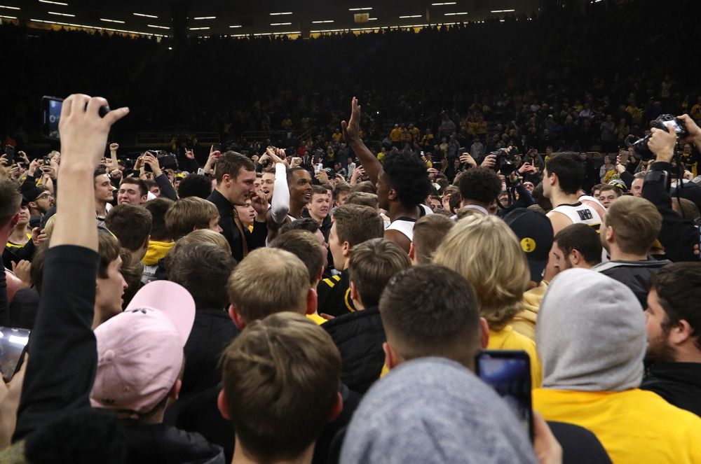 Iowa Hawkeyes guard Maishe Dailey (1) and forward Tyler Cook (25) celebrate with fans after defeating the Michigan Wolverines Friday, February 1, 2019 at Carver-Hawkeye Arena. (Brian Ray/hawkeyesports.com)