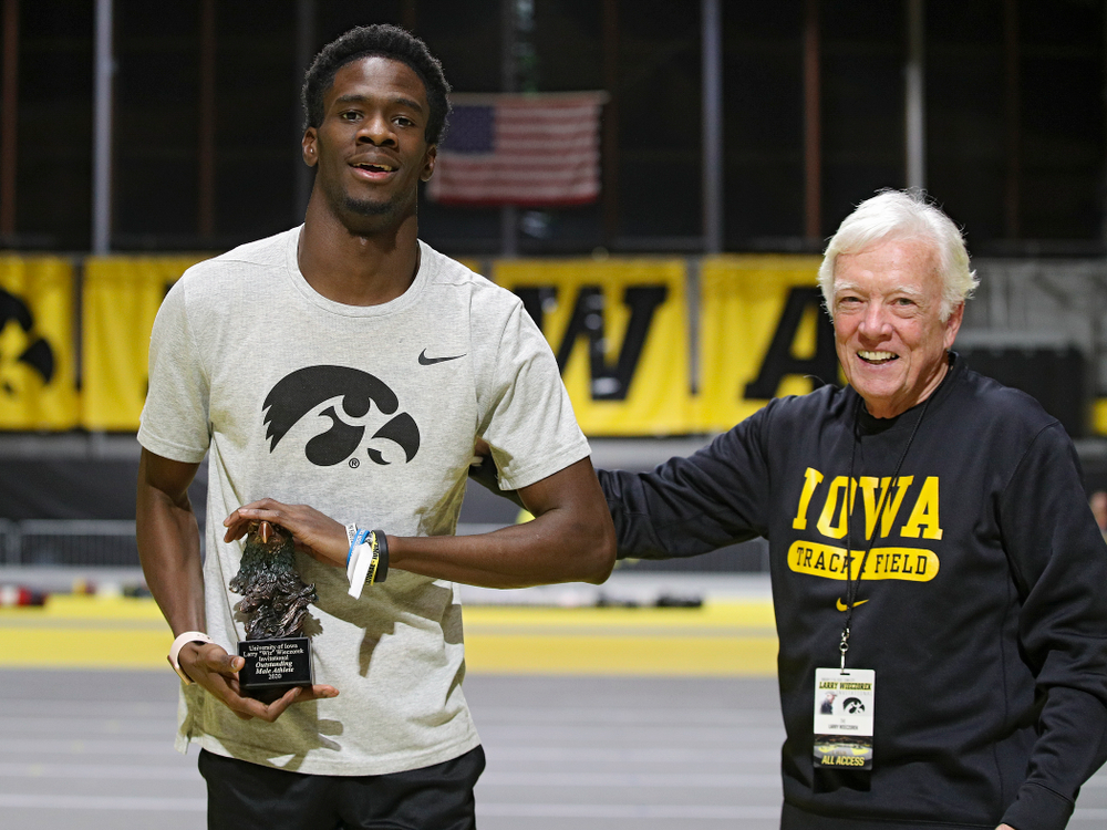 Iowa’s Wayne Lawrence Jr. (from left) receives an award from Larry Wieczorek during the Larry Wieczorek Invitational at the Recreation Building in Iowa City on Saturday, January 18, 2020. (Stephen Mally/hawkeyesports.com)