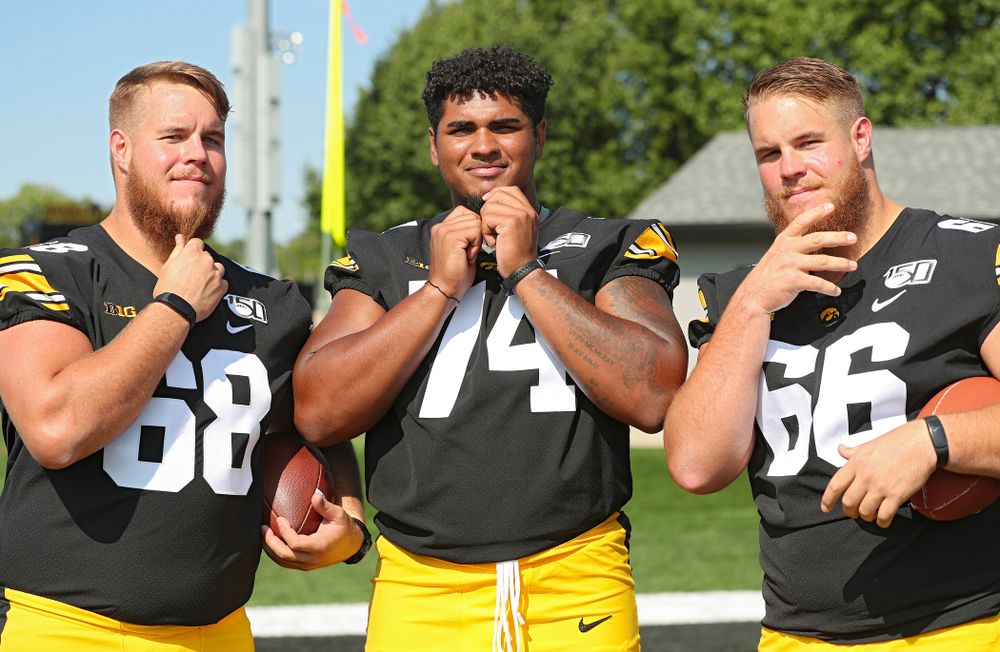 Iowa Hawkeyes offensive lineman Landan Paulsen (68), offensive lineman Tristan Wirfs (74), and offensive lineman Levi Paulsen (66) show off their beards during Iowa Football Media Day at the Hansen Football Performance Center in Iowa City on Friday, Aug 9, 2019. (Stephen Mally/hawkeyesports.com)