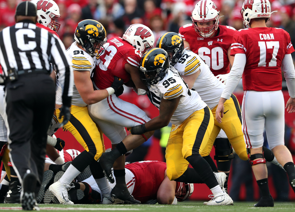 Iowa Hawkeyes defensive lineman Brady Reiff (91), defensive lineman Cedrick Lattimore (95), and defensive lineman John Waggoner (92) against the Wisconsin Badgers Saturday, November 9, 2019 at Camp Randall Stadium in Madison, Wisc. (Brian Ray/hawkeyesports.com)