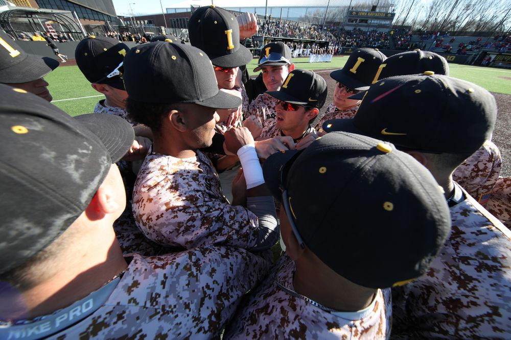The Iowa Hawkeyes gather before their game against the Nebraska Cornhuskers on Military Appreciation Night Friday, April 19, 2019 at Duane Banks Field. (Brian Ray/hawkeyesports.com)