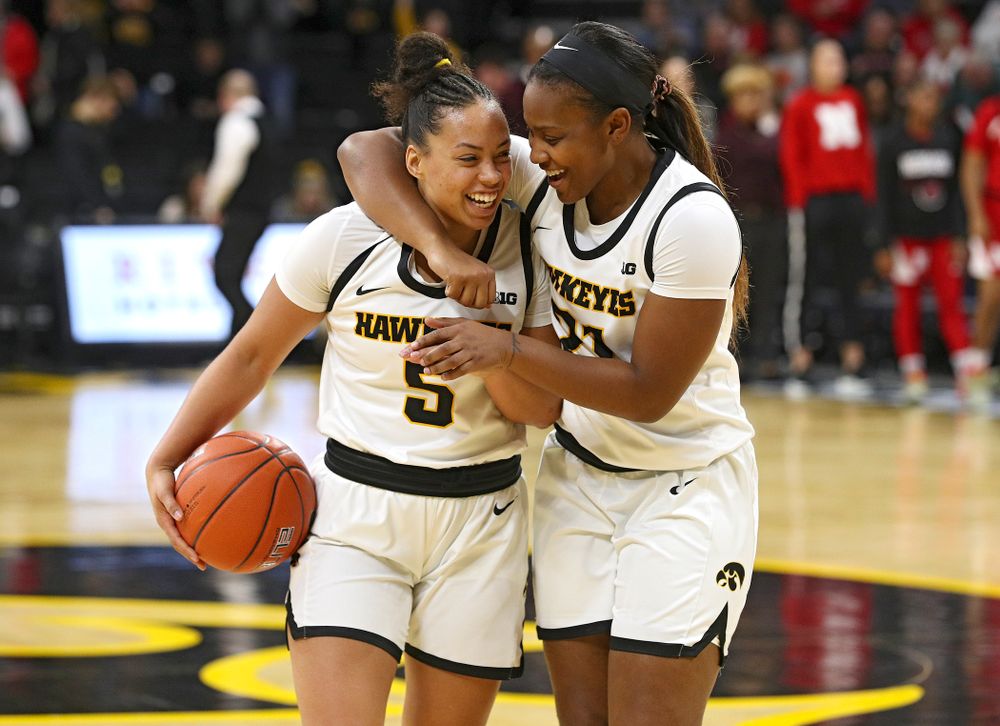 Iowa Hawkeyes guard Alexis Sevillian (5) celebrates with guard Zion Sanders (21) after winning their game at Carver-Hawkeye Arena in Iowa City on Thursday, February 6, 2020. (Stephen Mally/hawkeyesports.com)