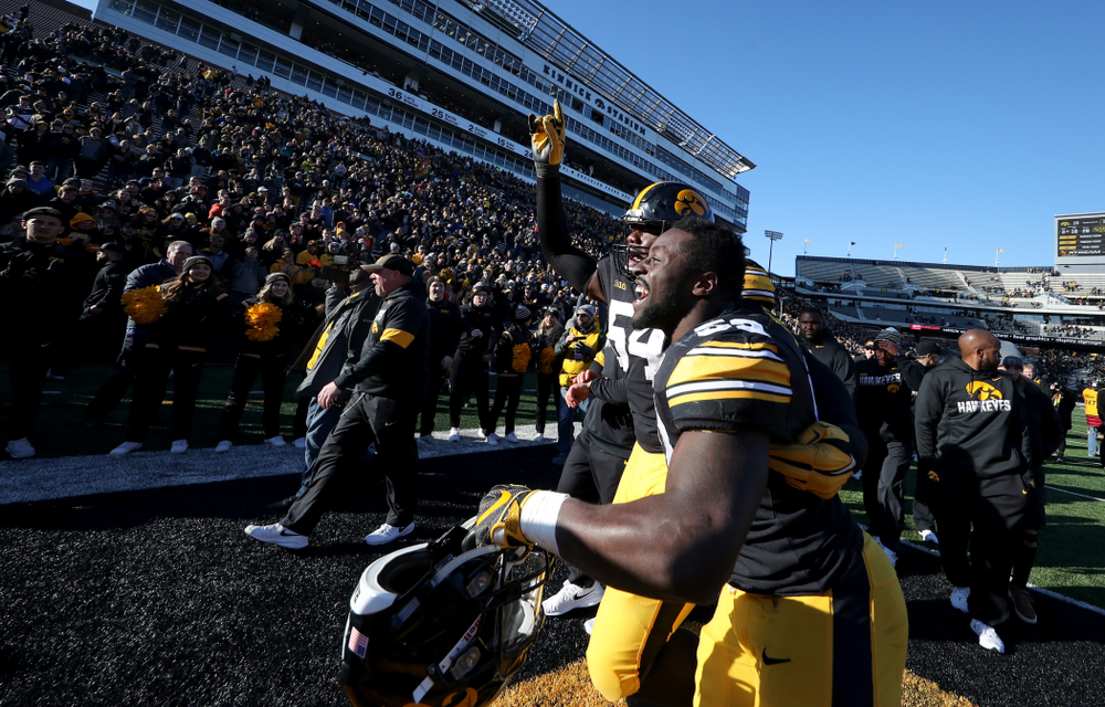 Iowa Hawkeyes defensive tackle Daviyon Nixon (54) and linebacker Amani Jones (52) against the Illinois Fighting Illini Saturday, November 23, 2019 at Kinnick Stadium. (Brian Ray/hawkeyesports.com)