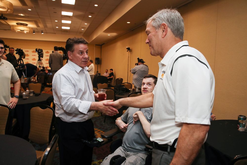 Iowa Hawkeyes head coach Kirk Ferentz shakes hands with Outback Bowl CEO Jim McVay during the Outback Bowl coaches press conference Saturday, December 29, 2018 in Tampa, FL. (Brian Ray/hawkeyesports.com)