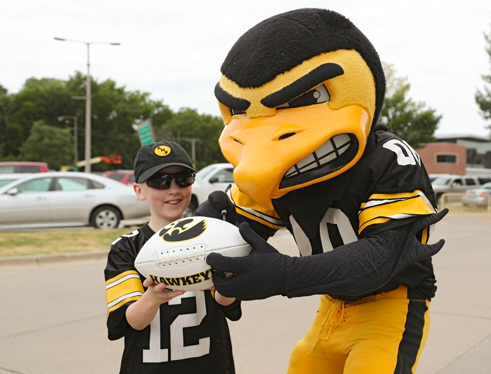 A young fan gets an autograph from Herky during Kids Day at Kinnick Stadium in Iowa City on Saturday, Aug 10, 2019. (Stephen Mally/hawkeyesports.com)