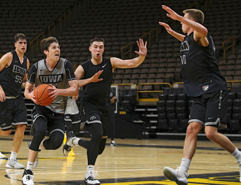 Iowa Hawkeyes forward Patrick McCaffery (22) looks to the basket as he drives in on guard CJ Fredrick (5) and guard Joe Wieskamp (10) during practice at Carver-Hawkeye Arena in Iowa City on Monday, Sep 30, 2019. (Stephen Mally/hawkeyesports.com)