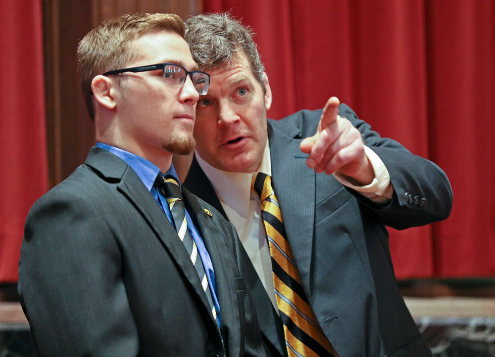 Iowa head coach Tom Brands (right) talks with Spencer Lee in the Senate Chamber at the Iowa State Capitol Building on Tuesday, Apr. 9, 2019. (Stephen Mally/hawkeyesports.com)
