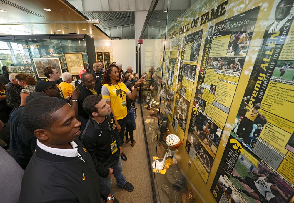 2019 University of Iowa Athletics Hall of Fame inductee Jeremy Allen, Eric Juergens, and Tangela Smith look at their exhibit after it was unveiled at the University of Iowa Athletics Hall of Fame in Iowa City on Friday, Aug 30, 2019. (Stephen Mally/hawkeyesports.com)