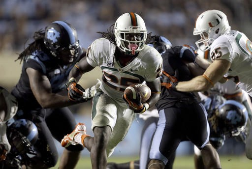 Miami's Dallas Crawford (25) carries the ball against North Carolina during the second half of an NCAA college football game in Chapel Hill, N.C.,...