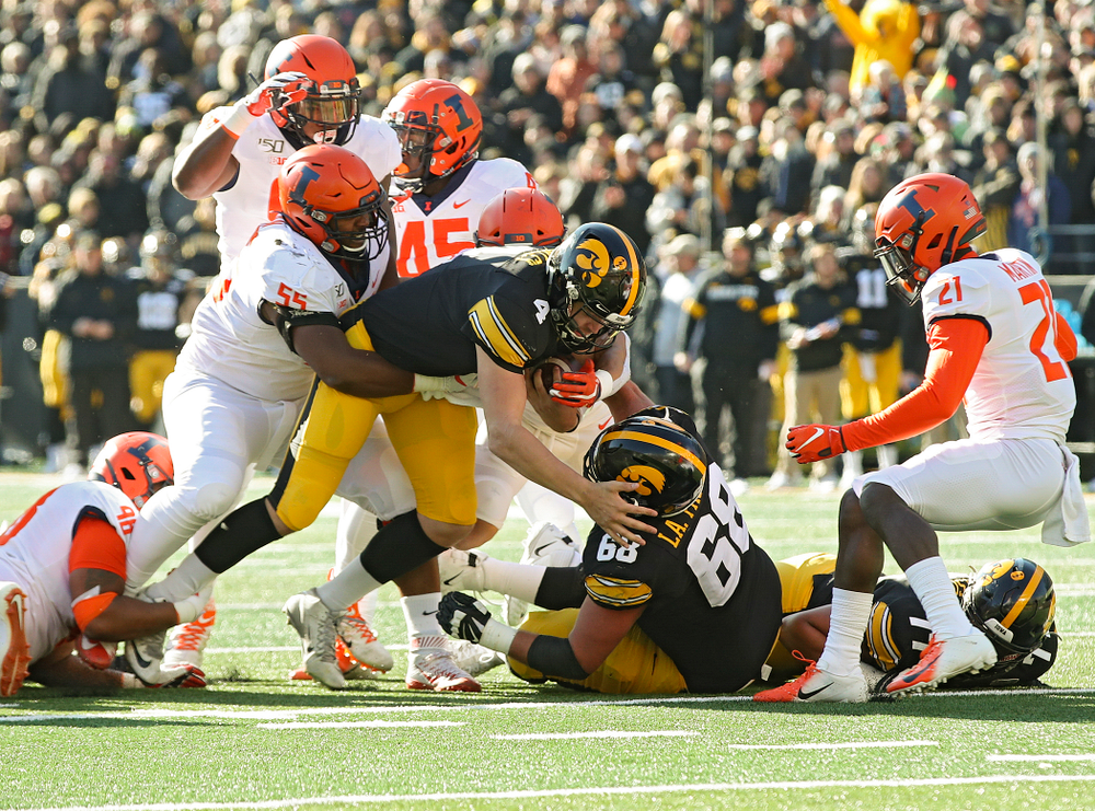Iowa Hawkeyes quarterback Nate Stanley (4) runs for a first down during the second quarter of their game at Kinnick Stadium in Iowa City on Saturday, Nov 23, 2019. (Stephen Mally/hawkeyesports.com)