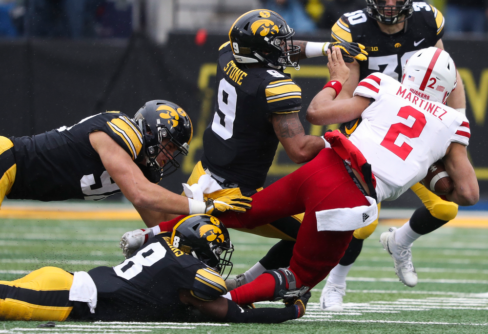 Iowa Hawkeyes defensive back Geno Stone (9) delivers a big hit on the quarterback during a game against Nebraska at Kinnick Stadium on November 23, 2018. (Tork Mason/hawkeyesports.com)