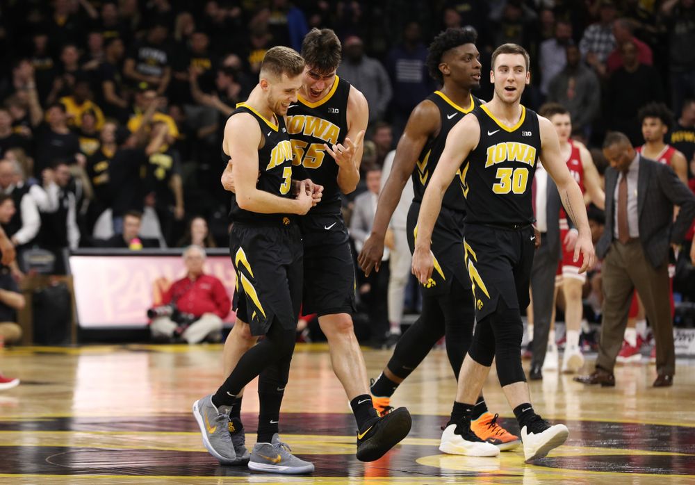 Iowa Hawkeyes guard Jordan Bohannon (3) celebrates with forward Luka Garza (55) after making a three point basket in overtime against the Indiana Hoosiers Friday, February 22, 2019 at Carver-Hawkeye Arena. (Brian Ray/hawkeyesports.com)