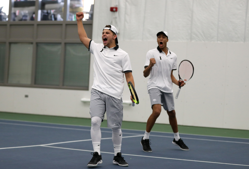 Iowa's Will Davies and Oliver Okonkwo celebrate after winning a doubles match against Western Michigan Saturday, January 19, 2019 at the Hawkeye Tennis and Recreation Complex. (Brian Ray/hawkeyesports.com)