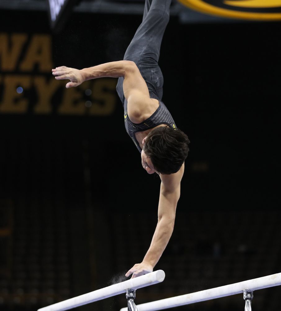 Iowa's Evan Davis competes on the parallel bars against the Ohio State Buckeyes Saturday, March 16, 2019 at Carver-Hawkeye Arena. (Brian Ray/hawkeyesports.com)