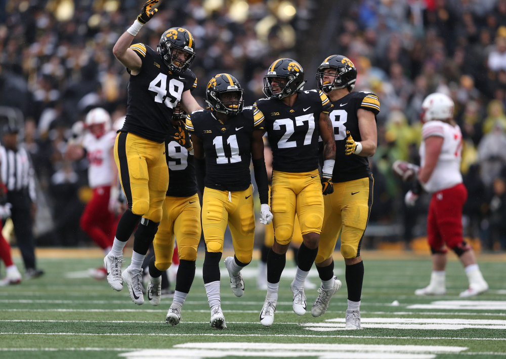 Iowa Hawkeyes defensive back Michael Ojemudia (11) celebrates after intercepting a pass against the Nebraska Cornhuskers Friday, November 23, 2018 at Kinnick Stadium. (Brian Ray/hawkeyesports.com)