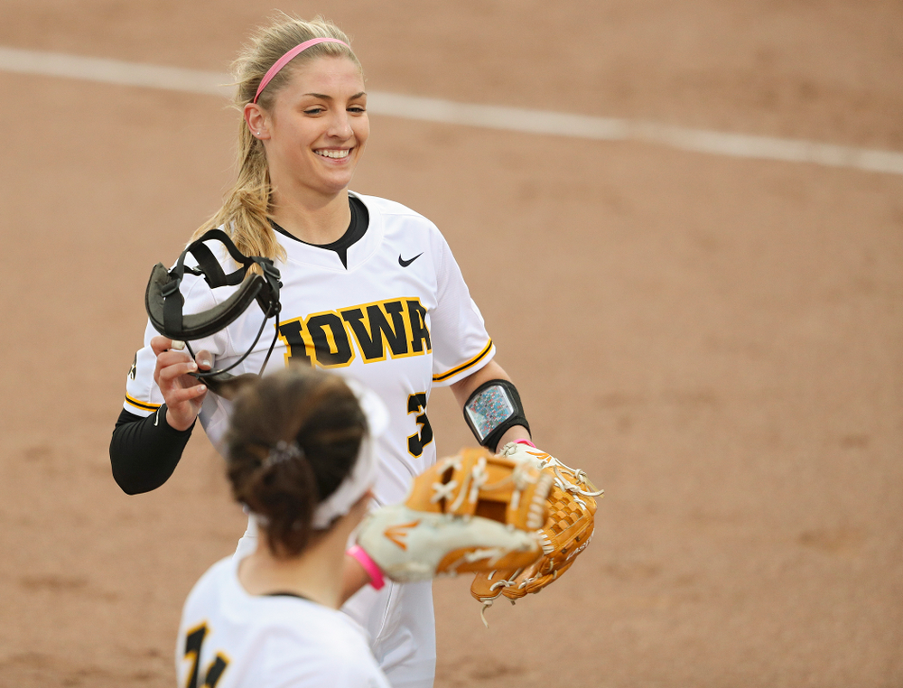 Iowa pitcher Allison Doocy (3) is greeted by third baseman Mallory Kilian (11) after a strikeout to end the top of the second inning of their game against Iowa State at Pearl Field in Iowa City on Tuesday, Apr. 9, 2019. (Stephen Mally/hawkeyesports.com)