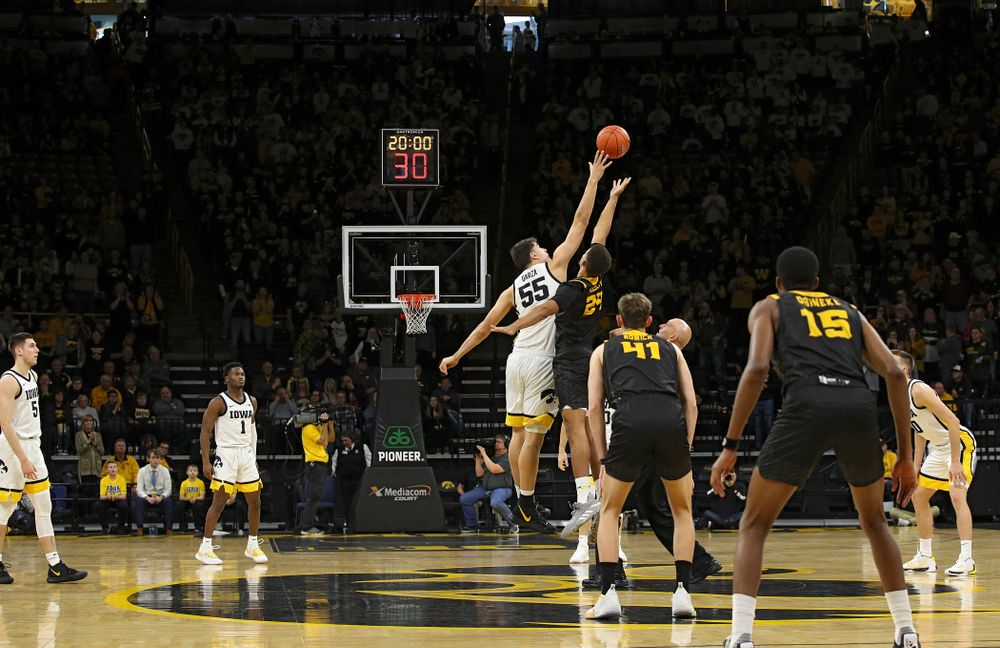 Iowa Hawkeyes center Luka Garza (55) wins the opening tipoff during the first half of their their game at Carver-Hawkeye Arena in Iowa City on Sunday, December 29, 2019. (Stephen Mally/hawkeyesports.com)