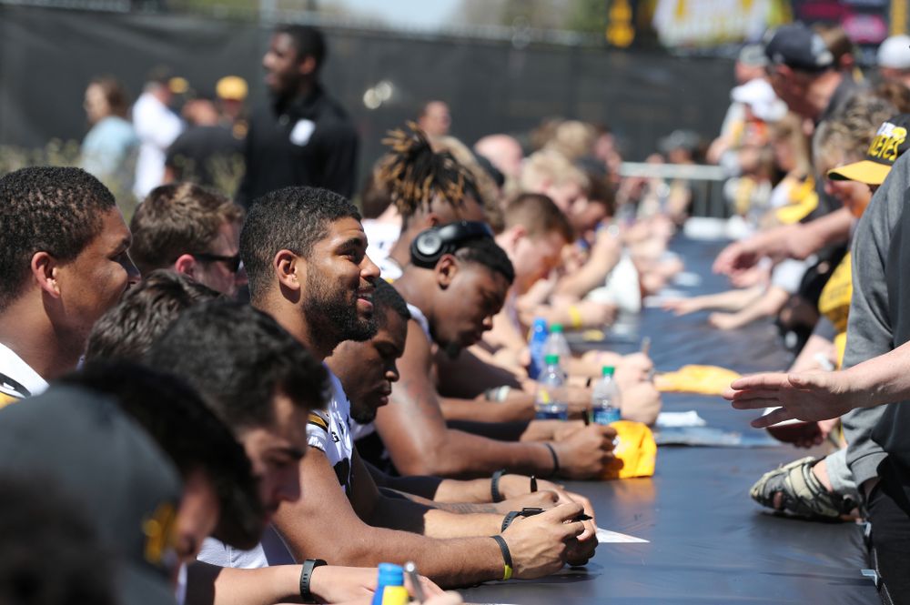 Members of the Iowa Football team sign autographs before the Iowa Hawkeyes game against the Nebraska Cornhuskers Saturday, April 20, 2019 at Duane Banks Field. (Brian Ray/hawkeyesports.com)