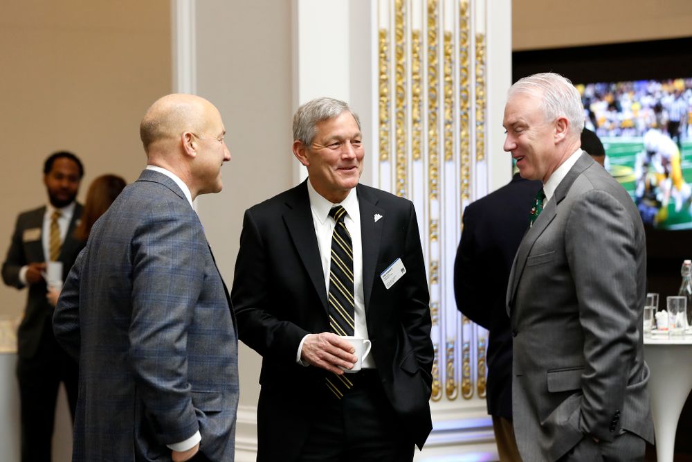 Iowa Hawkeyes linebacker Josey Jewell (43), defensive back Joshua Jackson (15), offensive lineman Sean Welsh (79) and head coach Kirk Ferentz ring the opening bell at the New York Stock Exchange Tuesday, December 26, 2017 in New York. (Brian Ray/hawkeyesports.com)