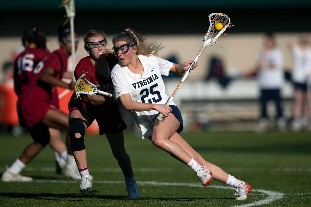 STANFORD, California - FEBRUARY 14: Virginia Cavaliers midfield Courtlynne Caskin (25) is defended by Stanford Cardinal midfield Jacie Lemos (33) during the first half at Cagan Stadium on February 14, 2020 in Stanford, California. The Virginia Cavaliers defeated the Stanford Cardinal 12-11. (Photo by Jason O. Watson)