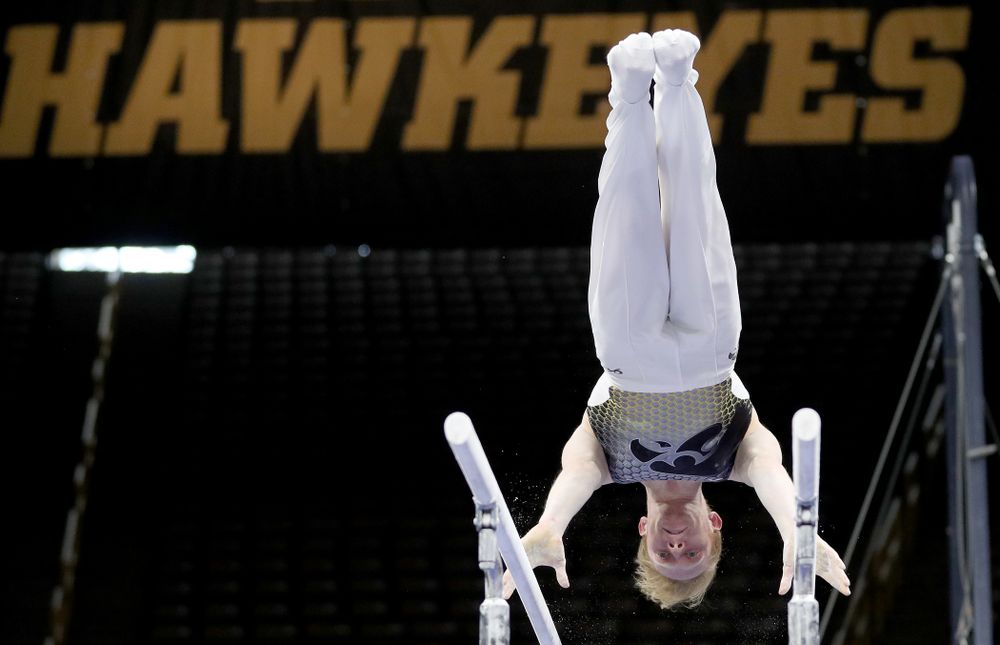 Iowa’s Nick Merryman competes on the parallel bars against Illinois Sunday, March 1, 2020 at Carver-Hawkeye Arena. (Brian Ray/hawkeyesports.com)